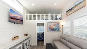 A spacious living area with a high ceiling, a balcony, and a view of the sky. - Near Beach • Pool + Amenities • Sleeps 8 (Middle Township)