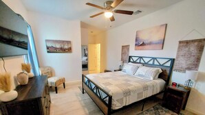 A bedroom with a bed, a dresser, a chair, a ceiling fan, and artwork on the walls. - 3BR●Private Bath Sweets●Game Room●Casino Nearby (Durant)