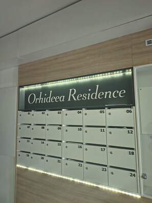 A wall-mounted mailbox with the label 'Orhideea Residence' above a row of numbered mail slots.