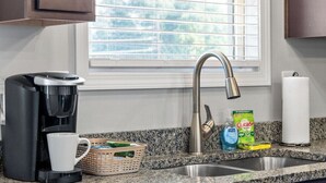 A kitchen with a coffee maker, a basket, a bottle of dish soap, and a paper towel dispenser. - 19th Hole Haven in Sango 1625 Golf Club, #601 (Clarksville)