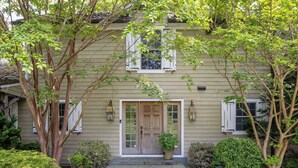 A house with a front door, two windows, and a small porch. - Summerset Villa by Rove - Family Home With Pool & Hot Tub (Bridgehampton)