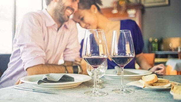 A dining table with two wine glasses and a plate of bread. - Romantic Napa Escape Prime Location King Bed, Private Patio & Pool (Napa)