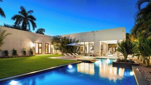 A modern house with a swimming pool, large windows, and a well-maintained lawn. - Villa Maroc by Rove Travel Luxury Oasis w/ Pool (Miami)