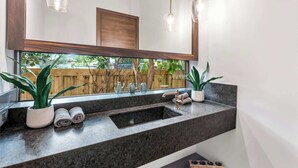 A bathroom with a large mirror, a sink, and two potted plants. - Villa Maroc by Rove Travel Luxury Oasis w/ Pool (Miami)