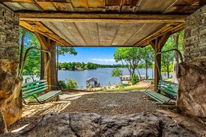 A covered viewing area with benches overlooking a lake, surrounded by trees and a gazebo. - Nancy Key (Sherrills Ford)