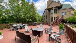 A deck with outdoor furniture, a grill, and a house with a staircase. - CR1 Bretton Woods (Bretton Woods)