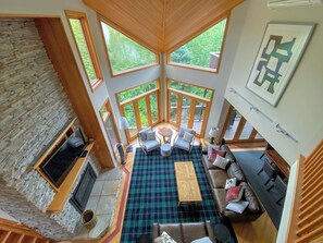 A spacious living area with a fireplace, large windows, and a cozy seating arrangement. - CR1 Bretton Woods (Bretton Woods)