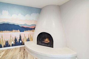 A modern fireplace with a mural of a forest and mountains in the background. - Spacious Scottsdale Retreat With Pool (Tempe)