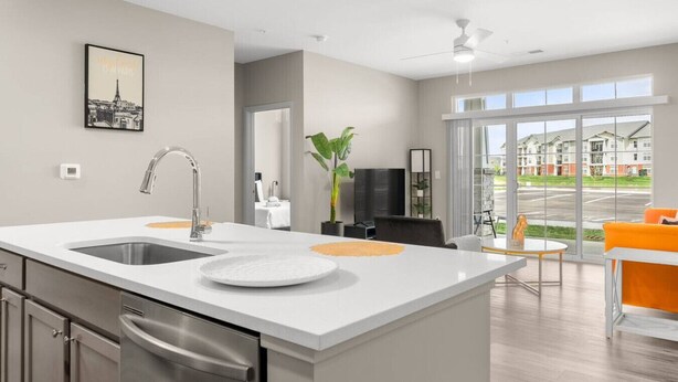 A modern kitchen with a large island, stainless steel appliances, and a large window offering a view of the outside. - Spacious Whitestown Getaway (Whitestown)