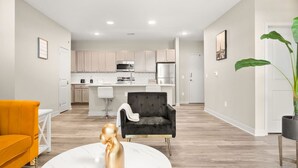 A modern apartment with a kitchen, living room, and dining area. - Spacious Whitestown Getaway (Whitestown)