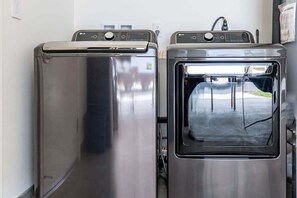 Two stainless steel front-loading washers in a laundry room. - @ Marbella Lane - Mesmerizing Ocean + MT Views (Waianae)