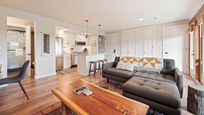 A modern apartment with a living room, kitchen, and dining area. - Seventh Mountain 1417 (Bend)