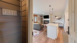 A modern interior with a wooden exterior, a kitchen area, and a living space. - Seventh Mountain 1417 (Bend)
