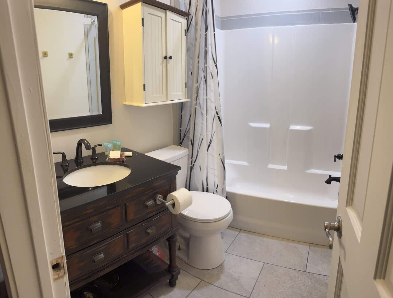 A bathroom with a sink, toilet, and bathtub.