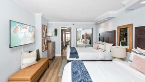 A modern hotel room with a large bed, a sofa, a TV, and a desk. - Caravelle 1445 (Myrtle Beach)