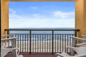 A balcony with a view of the ocean, white wicker chairs, and a metal railing. - Caravelle 1445 (Myrtle Beach)