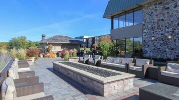 An outdoor patio area with seating and a fire feature.