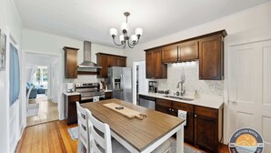 A modern kitchen with wooden cabinets, stainless steel appliances, and a central island. - Walk to Lake Relaxing Williams Bay Getaway (Williams Bay)