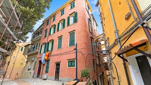 A narrow street with buildings on either side, featuring balconies and a mix of architectural styles. - Festival Riviera House Sanremo Old Town Sleeps 4, Sanremo, Italy (Sanremo)
