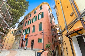 A narrow street with buildings on either side, featuring balconies and a mix of architectural styles. - Festival Riviera House Sanremo Old Town Sleeps 4, Sanremo, Italy (Sanremo)