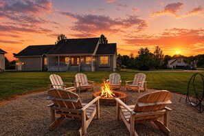 A house with a fire pit and Adirondack chairs in the yard. - Exclusive Buckner retreat w/ theater & game room! (Buckner)