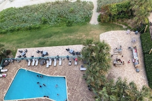 An outdoor swimming pool with lounge chairs and a patio area. - Oceanfront studio with private balcony, pool & direct beach access (Myrtle Beach)