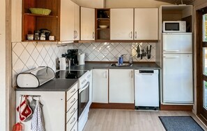 A compact kitchen with white cabinets, a microwave, a dishwasher, and a coffee maker. - 3 bedroom gorgeous home in Stubbekøbing (Stubbekøbing)