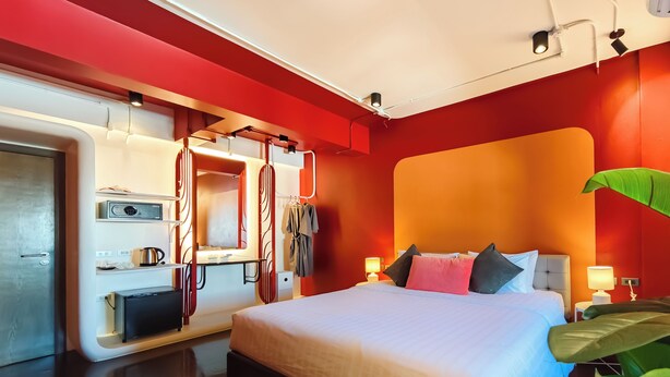 A modern hotel room with a large bed, bedside tables, a built-in wardrobe, and a mirror. - DAY & NIGHT by THE MOMENT (Chiang Mai)