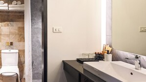 A bathroom with a toilet, shower curtain, sink, and mirror. - DAY & NIGHT by THE MOMENT (Chiang Mai)
