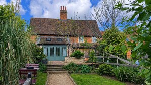 A traditional brick house with a green door, a stone staircase, and a gravel path leading to the entrance. - The Smithy's Cottage -  a cottage that sleeps 4 guests  in 2 bedrooms (Freston)
