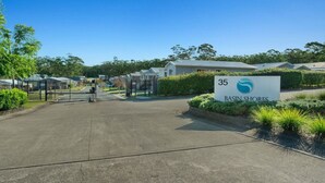 A gated entrance to a residential area with a sign reading 'Basin Shores' and a number '35' indicating a specific unit or location. - Cosy Villa - Pool Tennis & More | Pay 2 Stay 3 (Saint Georges Basin)