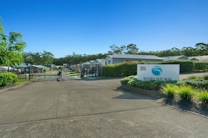 A gated entrance to a residential area with a sign reading 'Basin Shores' and a number '35' indicating a specific unit or location. - Cosy Villa - Pool Tennis & More | Pay 2 Stay 3 (Saint Georges Basin)
