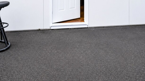 A white building with a door, a small window, and a black object on the wall. - Cozy Studio Suite (Tukwila)