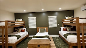 A room with bunk beds, a central bed, and a wooden chest. - Casa De Hot Springs (La Verkin)