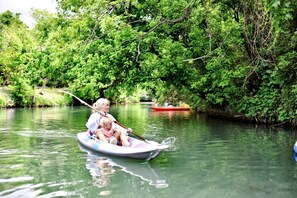 A river scene with a boat carrying two people.