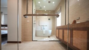 A modern bathroom with a glass-enclosed shower, a white bathtub, and wooden cabinetry. - La Villa des Chien (Sattahip)