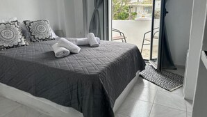 A bedroom with a bed, pillows, a window, and a view of the outside. - Tranquil Guest Room Retreat in Vothonas, Greece (Vothonas)