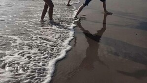 Three people dancing on a beach with waves. - Lyons Sunnysands Holiday Park - Holiday Accommodation 20099 (Talybont)