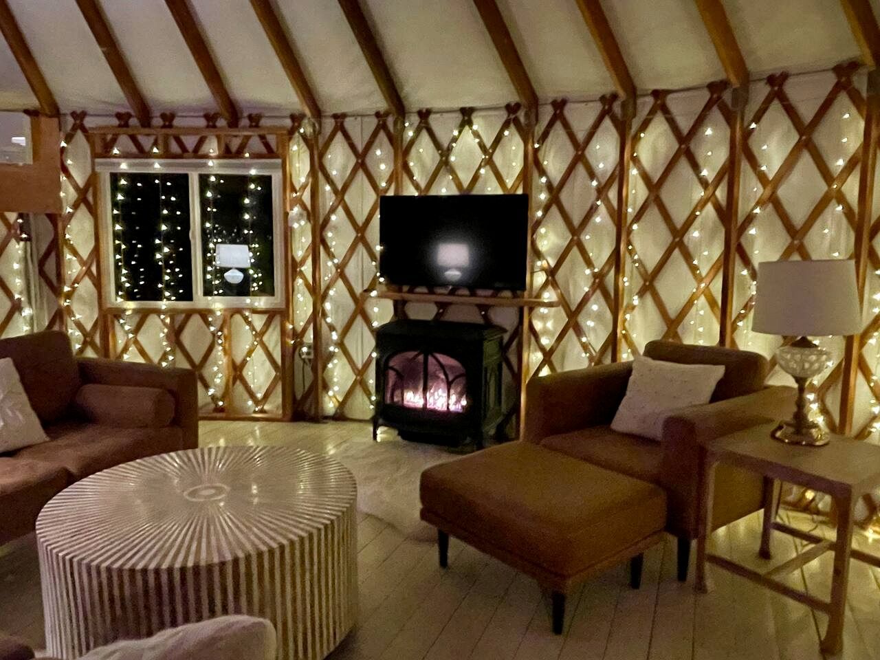 A cozy room with a fireplace, a television, and a comfortable seating area.