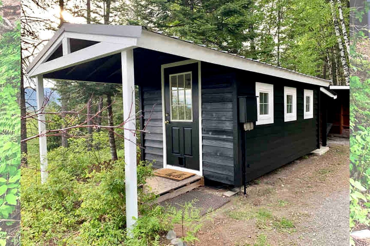 A small cabin with a porch, a door, and a window.
