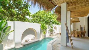 A pool area with a curved design, white walls, and potted plants. - Stunning 3BR Villa • Rooftop Pool • 3min to Beach Balangan (Badung)