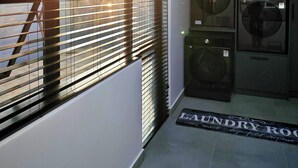 A laundry room with a skylight, a washing machine, and a dryer.