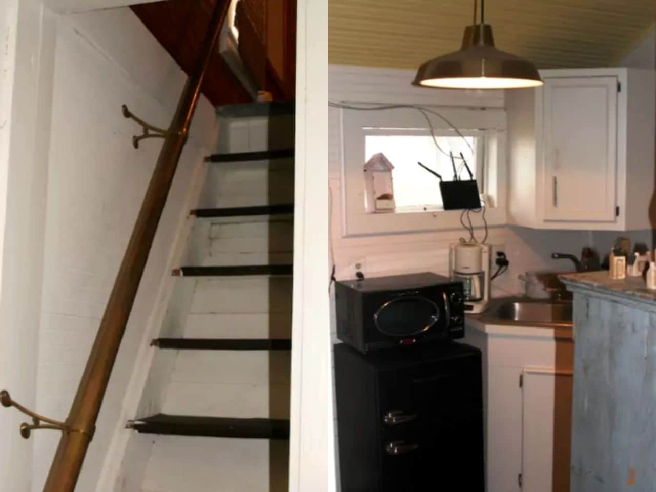 En trappa med ett träräcke och vita väggar, ett kök med vita skåp, en mikrovågsugn och en hängande lampa.