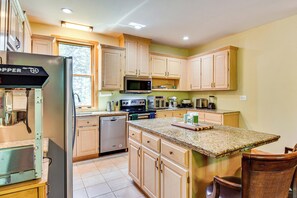A kitchen with wooden cabinets, a stainless steel refrigerator, a microwave, and a dishwasher. - 6 Mi to South Cove Boat Ramp! Lake Keowee Escape (Seneca)