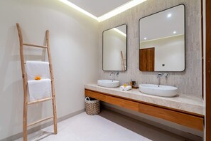 A bathroom with two sinks, wooden vanity, large mirrors, and a wooden ladder. - Villa Eden by Elysian (Kerobokan)