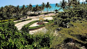 A landscaped area with palm trees, a central garden feature, and a view of the ocean. - My Marina Beach Hotel Phu Quoc (Phu Quoc)