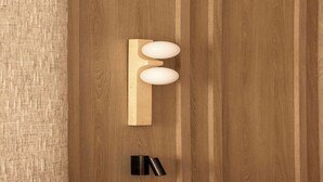 A wooden door with a modern, minimalist handle and a small, black, cylindrical object below it. - Design Apartment a/c 1BR/4P - Saint-Germain (Paris)