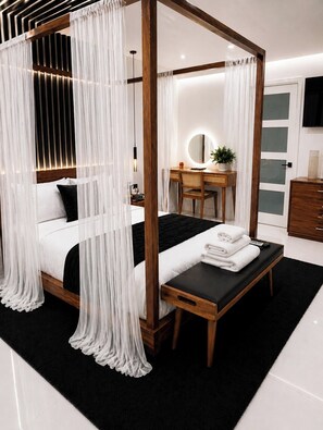 A bedroom with a four-poster bed, a desk with a chair, a mirror, and a dresser. - Waterfront Luxury Home Prime Location Near Hard Rock Stadium - Beach & Airport (Hollywood)