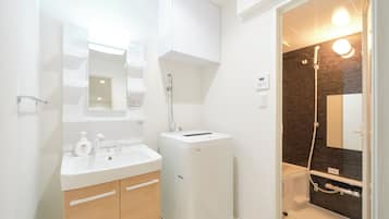 Shower, hair dryer, slippers, towels