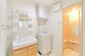 Shower, hair dryer, slippers, towels